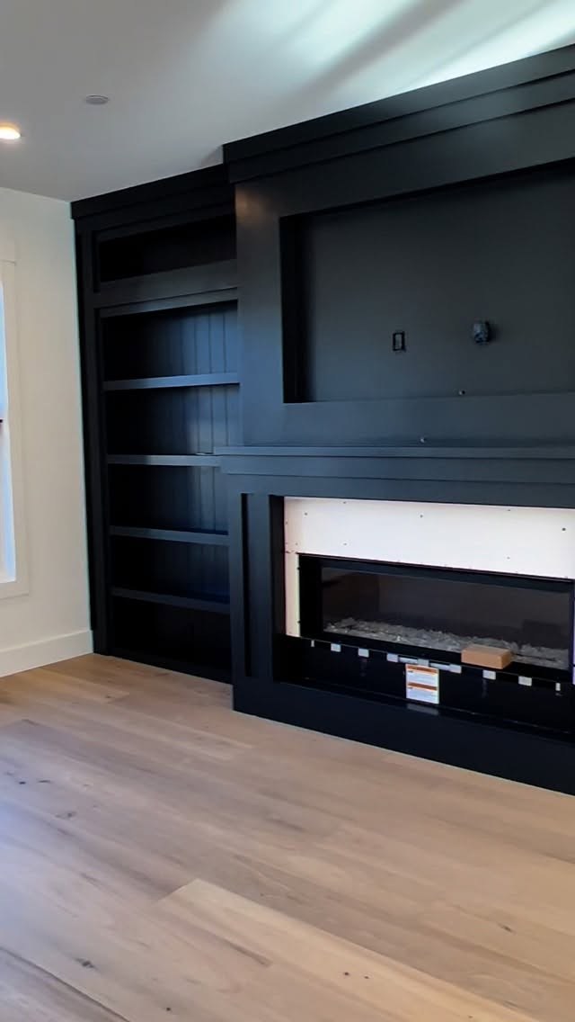Custom black built-in millwork and fireplace surround