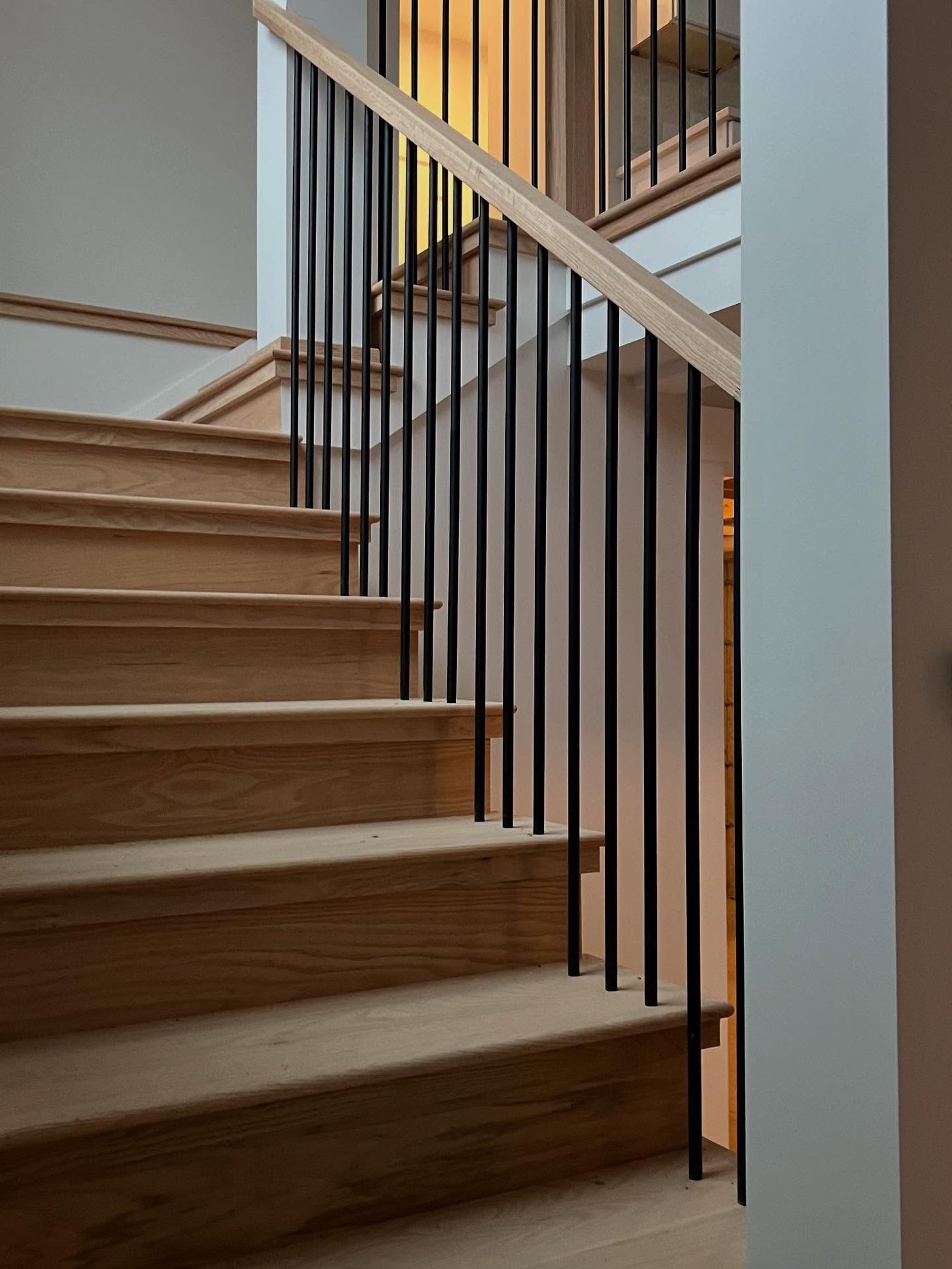 Custom staircase with black metal spindle railing